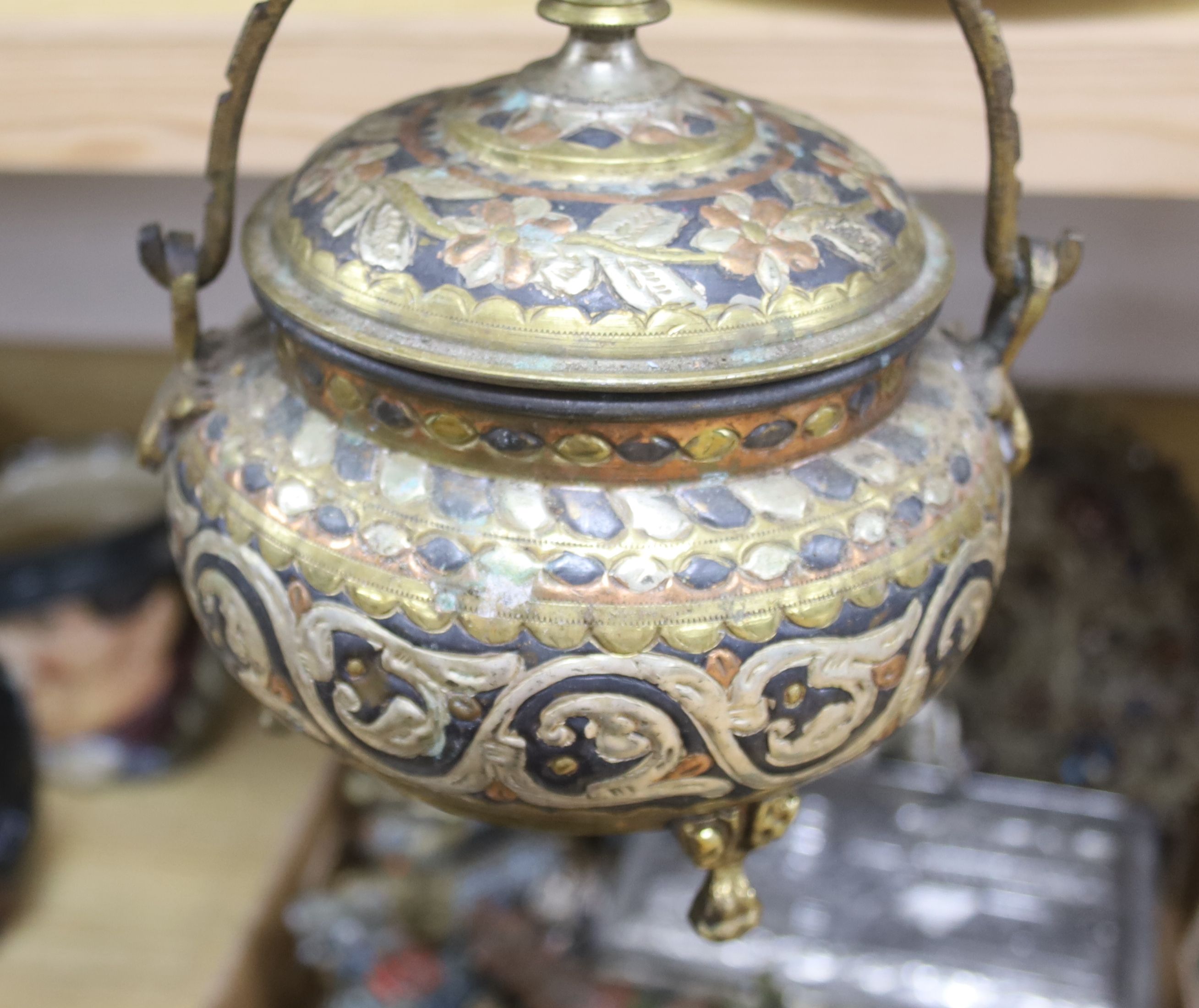 A group of Tibetan style metalware figures, masks, ornaments, etc.